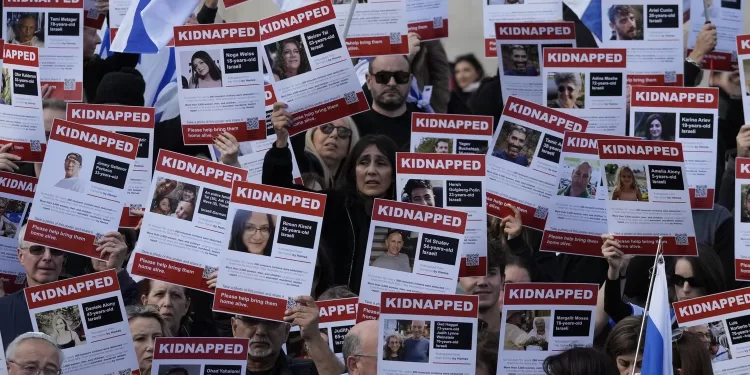 Israeli supports show placards with the faces and names of people believed to be taken hostage and held in Gaza, during a protest in Trafalgar Square, London, Sunday, Oct. 22, 2023. They are demanding the release of all hostages allegedly taken by the militant group Hamas. (AP Photo/Frank Augstein)