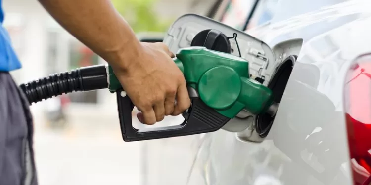 Refueling Car With Gasoline Pump Nozzle, Selective Focus on pump nozzle